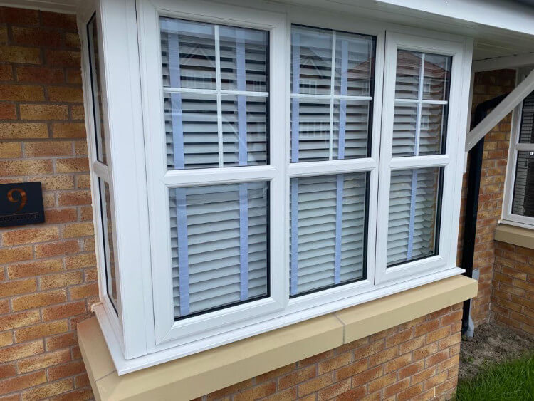 window with white venetian blinds